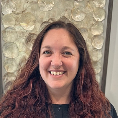 Dental Assistant Audra Smiling In Front Of Art Piece