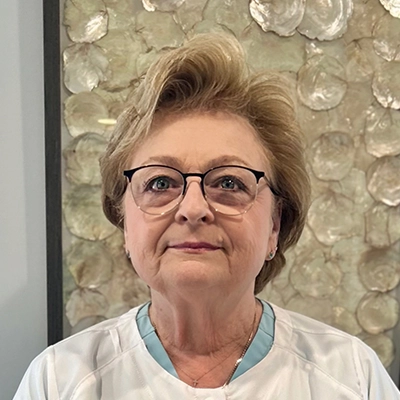 Dental Hygienist Glenda Smiling In Front Of Art Piece