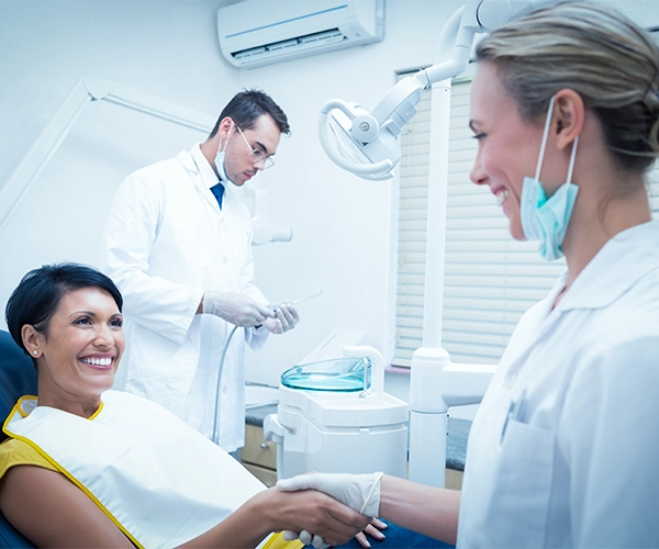 Lady Smiling In Dental Exam Chair Meeting Denstist